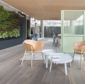 A modern office space with a living green wall, white furniture, and a green wall divider.