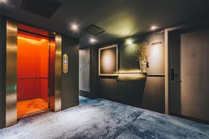 Modern hotel lobby featuring metallic finishes and contemporary design elements.
