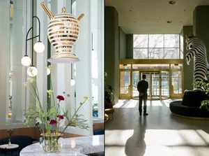 A modern lobby with glass and gold decorative elements.