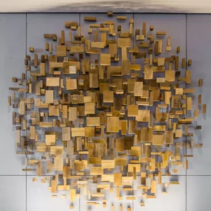 An abstract artwork installation featuring various wooden blocks arranged in a geometric pattern on a wall.