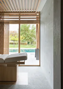 Interior view of a minimalist spa with concrete and wooden elements.