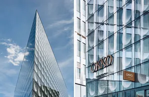 Modern triangular structure with glass facade and geometric design.