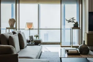 Contemporary living room featuring floor-to-ceiling glass windows.