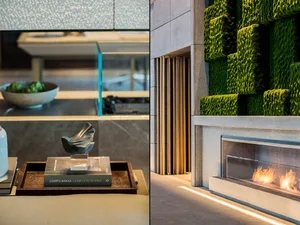 A modern living room featuring a green living wall and a fireplace.
