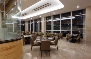 A stylish, modern restaurant interior featuring marble flooring and contemporary decor.