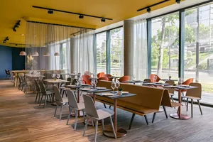 Modern restaurant interior with minimalist design and contemporary materials.