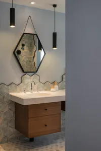 Modern bathroom interior with hexagonal tiles and concrete countertop