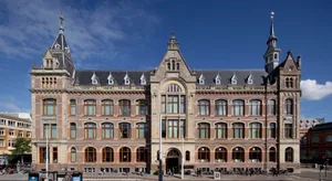 Classical stone and brick building with multiple floors and windows.