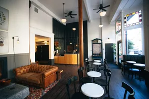 Interior of a coffee shop with wooden tables and metal chairs