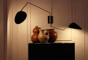 Industrial-style interior design featuring ceramic vases on a cabinet.