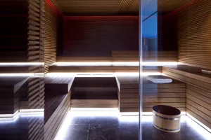 Modern industrial style spa room with wooden interiors and built-in seating.