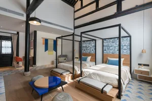 A minimalist residential room with wooden furniture and metal accents.