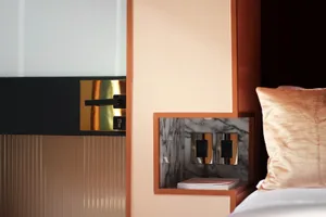 Close-up of a modern bedroom featuring a metal accent wall.