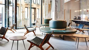 Modern coffee shop with wooden chairs and leather seating.