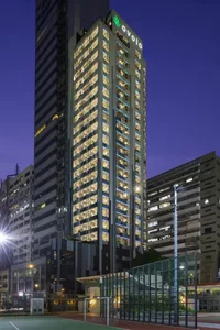 A modern office building with a glass façade at night.
