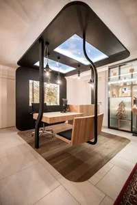 A modern office space featuring wooden furnishings and a unique, open-air design.