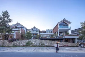 A modern residential exterior made of stone and wood