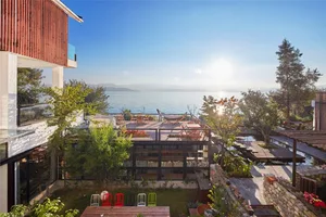 Modern vacation home with ocean view and wooden exterior.
