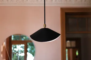 A modern interior design featuring a mid-century lighting fixture.