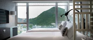 Modern white bedrooms with a view of the mountains.