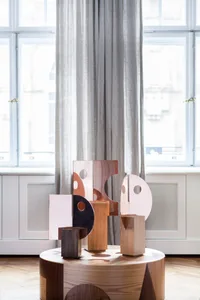 An abstract metal sculpture installation in an interior design setting.