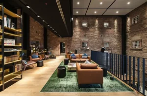 Modern lobby with brick walls, featuring contemporary furniture and minimalist design.