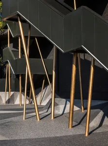Stairs with gold-colored metal legs and black walls and steps