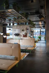 Modern interior design of a cafe showing concrete seating and industrial decor