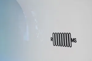 A minimalist logo design featuring a metallic representation of the letters RMMS on a white background.