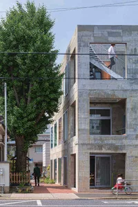 A minimalist apartment building constructed from concrete materials.