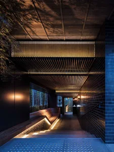 Modern industrial interior design featuring brick flooring and wooden elements.
