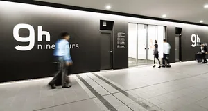 A modern retail storefront with black glass walls and a minimalist design.