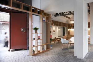 Interior of a coffee shop with wooden shelves, concrete floor, and natural light.