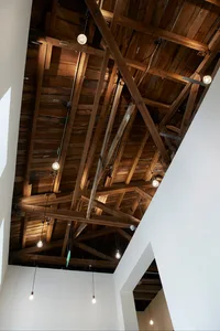 Exposed wooden ceiling beams and hanging light bulbs