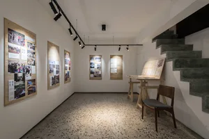 A minimalist exhibition space featuring wood and stone materials.