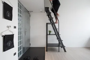A minimalist interior space with a modern black metal staircase