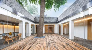 Modern interior design featuring wooden flooring and furniture.