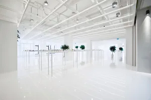 Modern office space with white concrete flooring and walls.