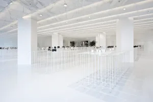 An empty minimalist office space with white flooring and walls.