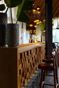 A photograph of a clean, modern bar counter with wood-texture details, showcasing sleek design.