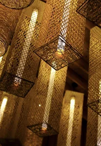 Decorative woven straw lighting fixtures in a restaurant setting.
