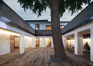 Modern office space with wooden floors and exterior view.