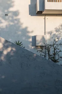 Modern house exterior featuring concrete and metal materials.