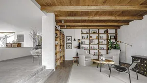 Modern minimalist living room with wooden furniture and shelves.