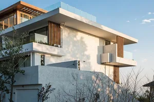 Modern house featuring concrete, glass, and wood materials.