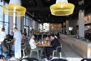 Industrial-style restaurant interior with metallic pendant lights and modern design