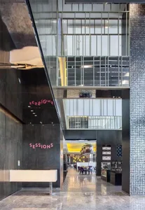 A modern commercial lobby with metal walls and concrete floors.