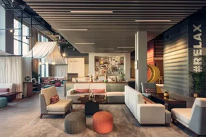 Contemporary hotel lobby featuring concrete, wood, and textile accents.