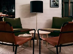 Modern living room featuring leather chairs and a wooden side table