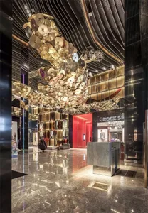 A modern lobby featuring metallic ceiling sculptures.